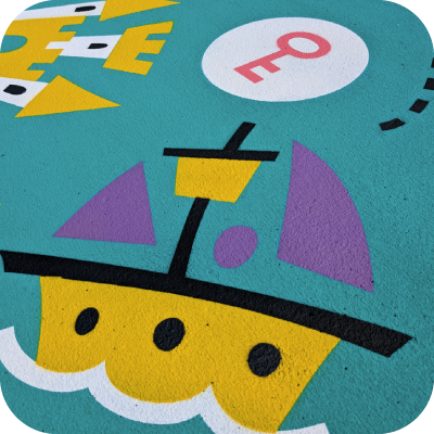 A brightly coloured path with a simply illustrated ship, key and castle.