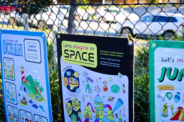 Imaginary Play Posters are attached to a wire fence